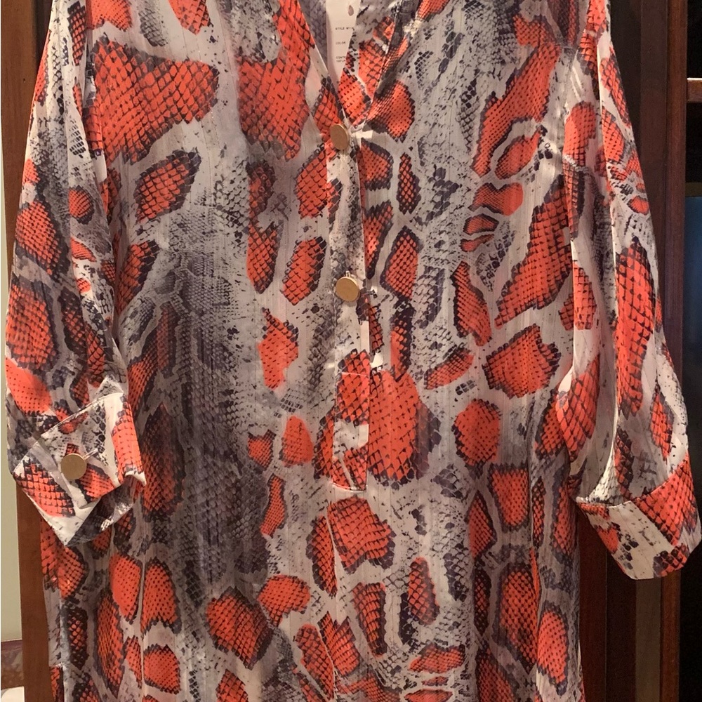 Orange and black snake print. Approximately 34” from shoulder to hem.